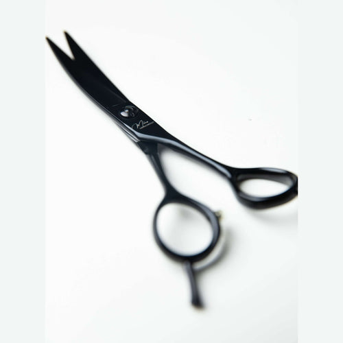 Ciseaux de coiffeur incurvés precision pour coupe de cheveux texturés et bouclés avec design professionnel.